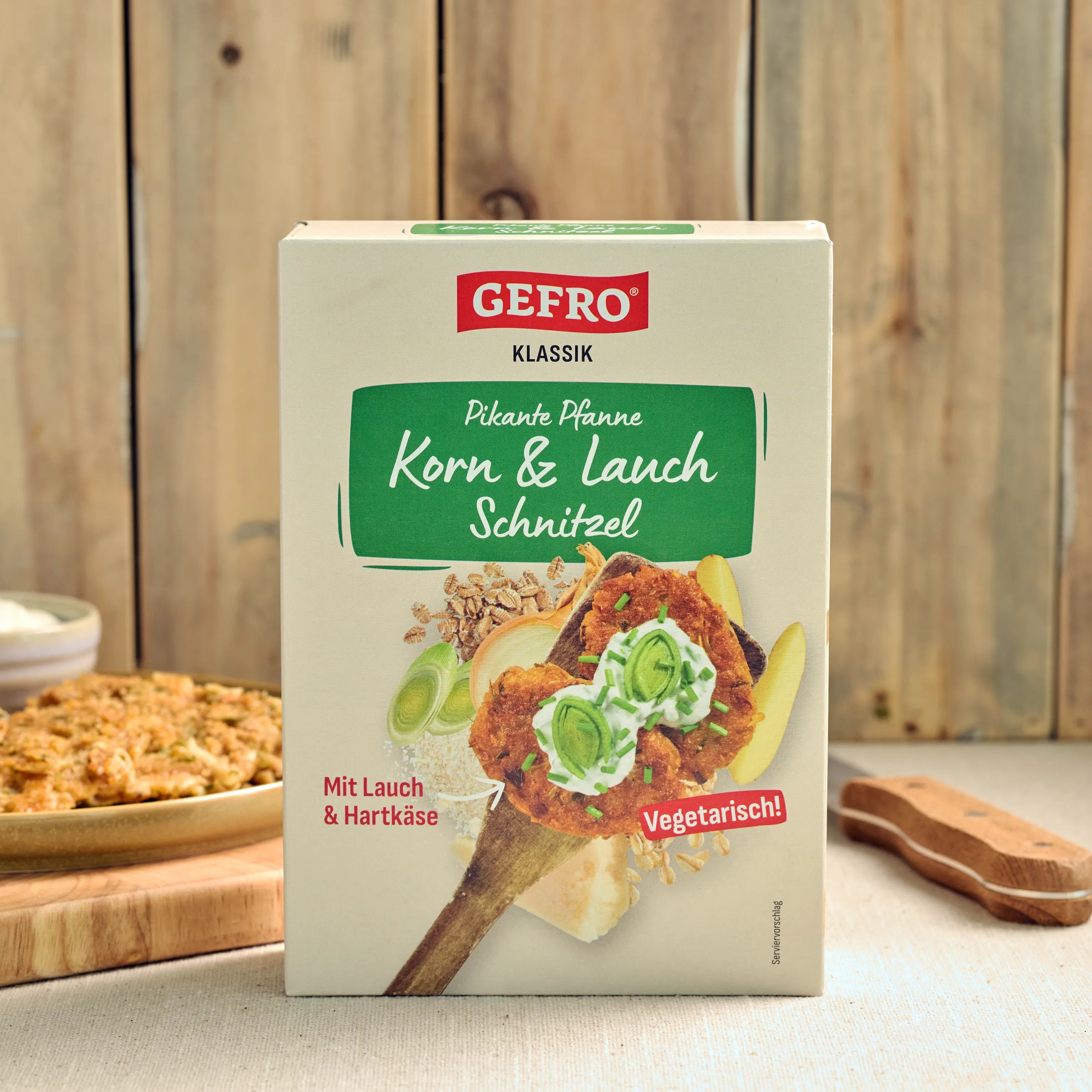 Verpackung von Gefro Klassik Korn & Lauch Schnitzel, vegetarische Pfanne mit Lauch und Hartkäse auf Holztisch