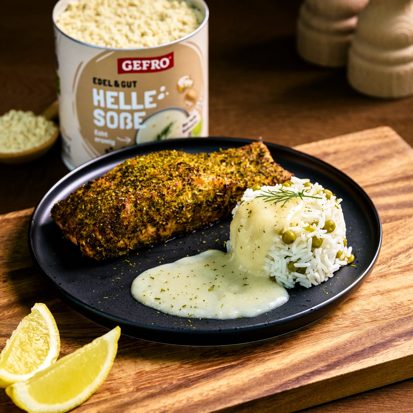 Teller mit gewürztem Fisch, Reis mit Erbsen und heller Soße; dahinter eine Dose GEFRO Helle Soße Edel & Gut.