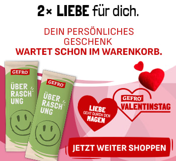 Zwei grüne Gefro-Überraschungsprodukte mit Smiley vor rosa Hintergrund. Textlicher Hinweis, dass ein persönliches Geschenk im Warenkorb bereitliegt. Valentinstagsmotiv mit Herzsymbol und Gefro-Logo.