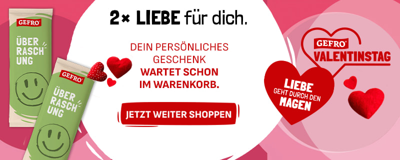 Zwei grüne Gefro-Überraschungsprodukte mit Smiley vor rosa Hintergrund. Textlicher Hinweis, dass ein persönliches Geschenk im Warenkorb bereitliegt. Valentinstagsmotiv mit Herzsymbol und Gefro-Logo.
